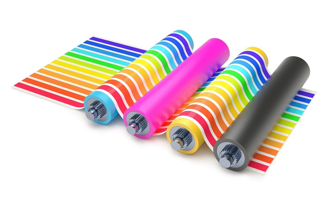 four different coloured rollers with multicoloured lined paper